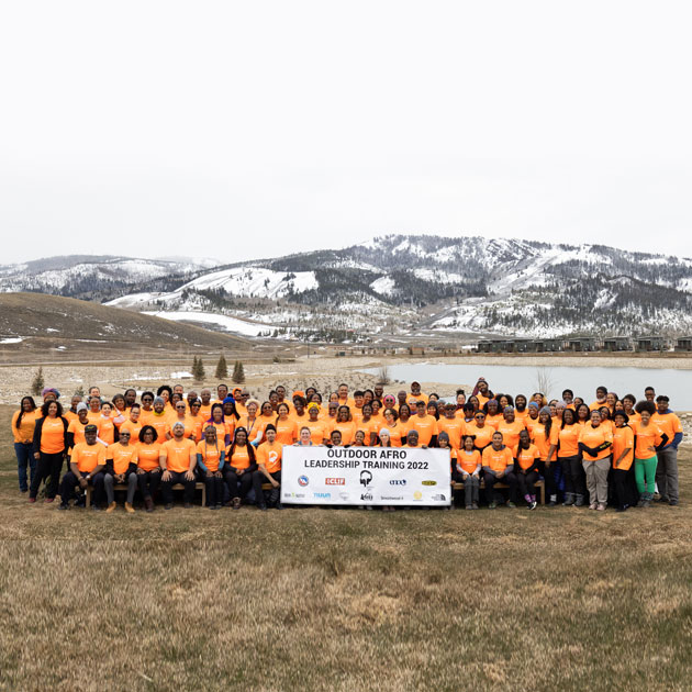 Group photo of the Outdoor Afro leadership training members posing in front of mountains.